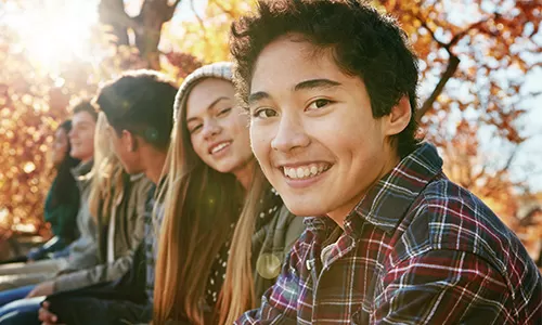 Teens together - Oregon State Credit Union Woman happy with rewards - Oregon State Credit Union